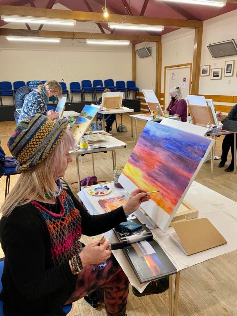 A lady painting a landscape